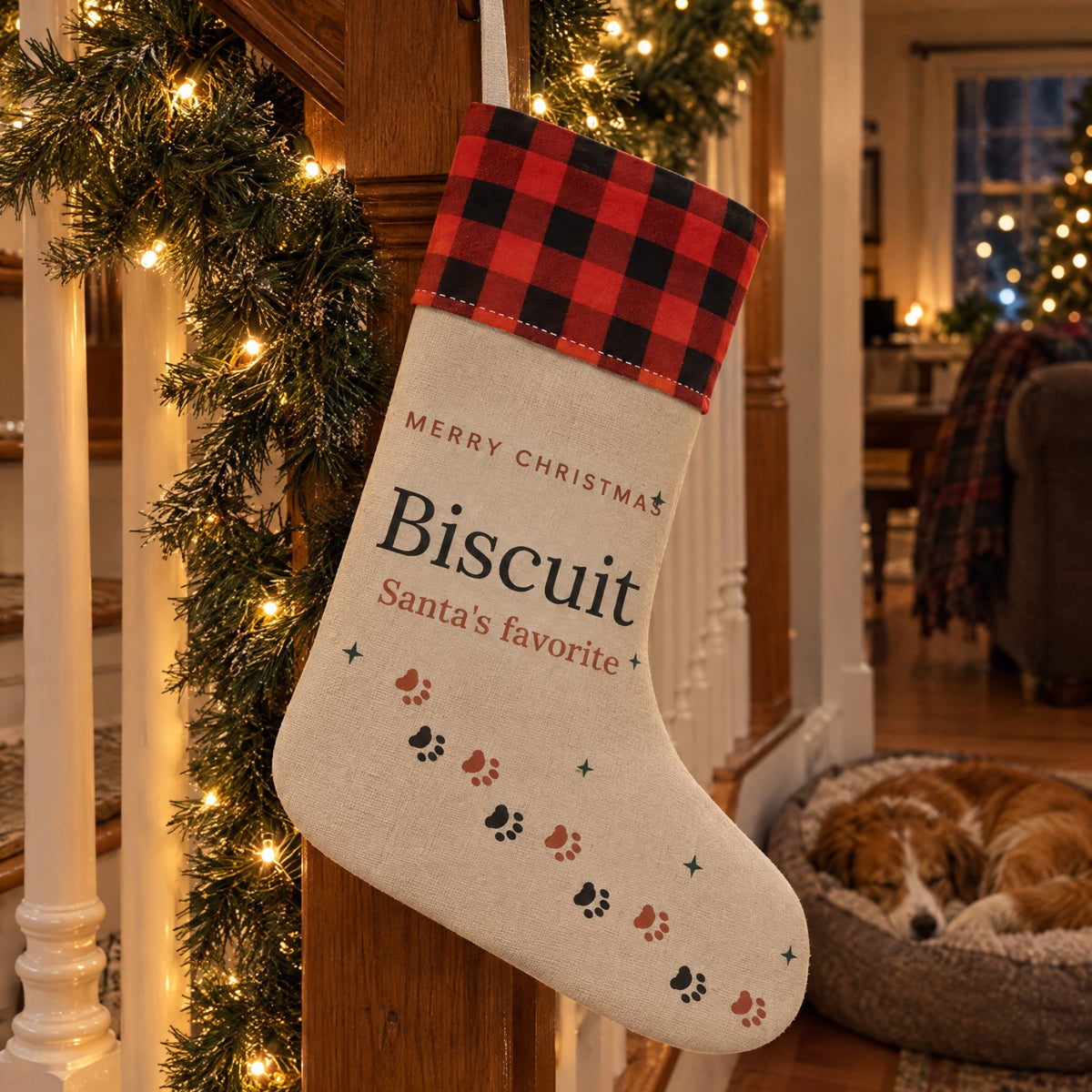 Pet name stocking hanging on a garland staircase with the dog asleep below